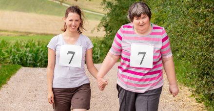 caregiver walking with special elderly woman