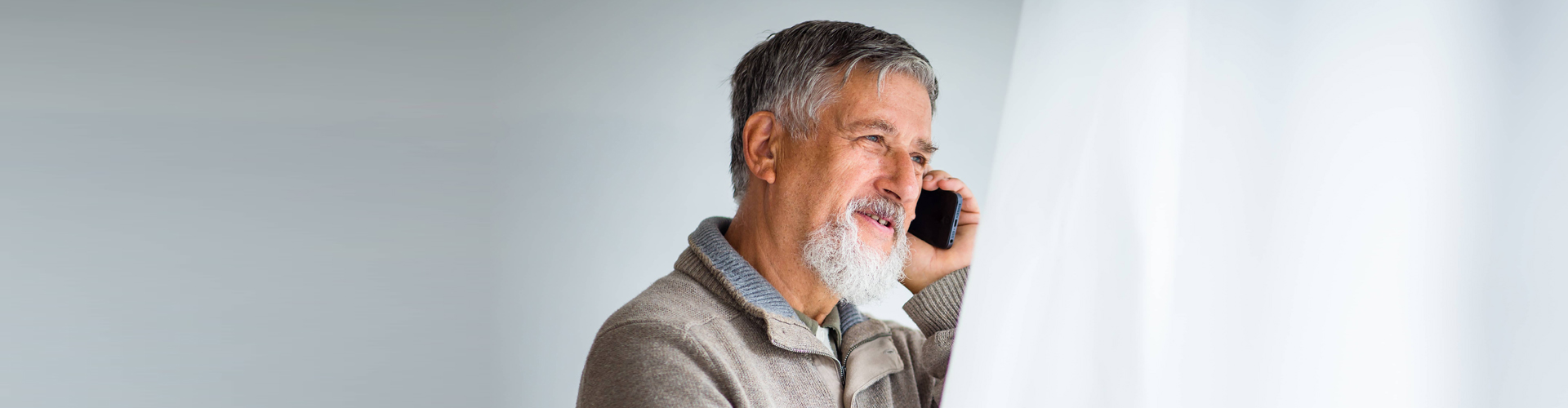 elderly man using the phone