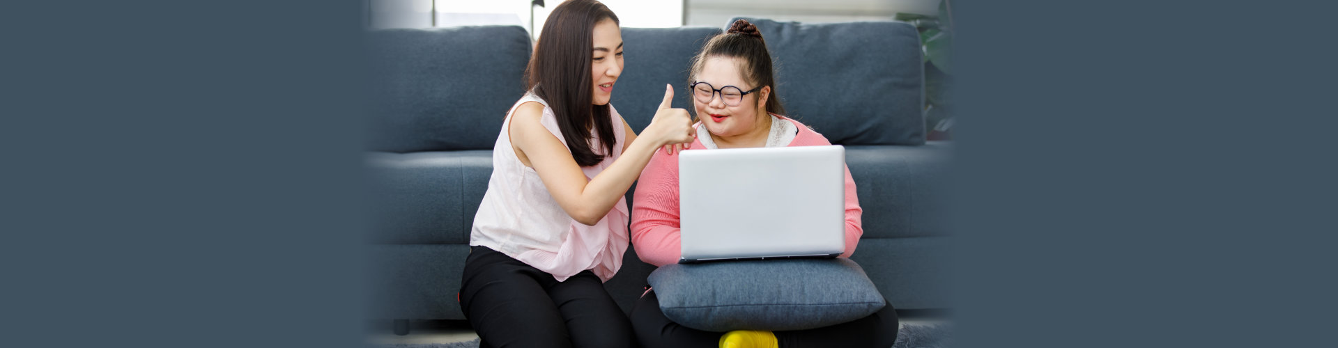 special woman using laptop together with caregiver